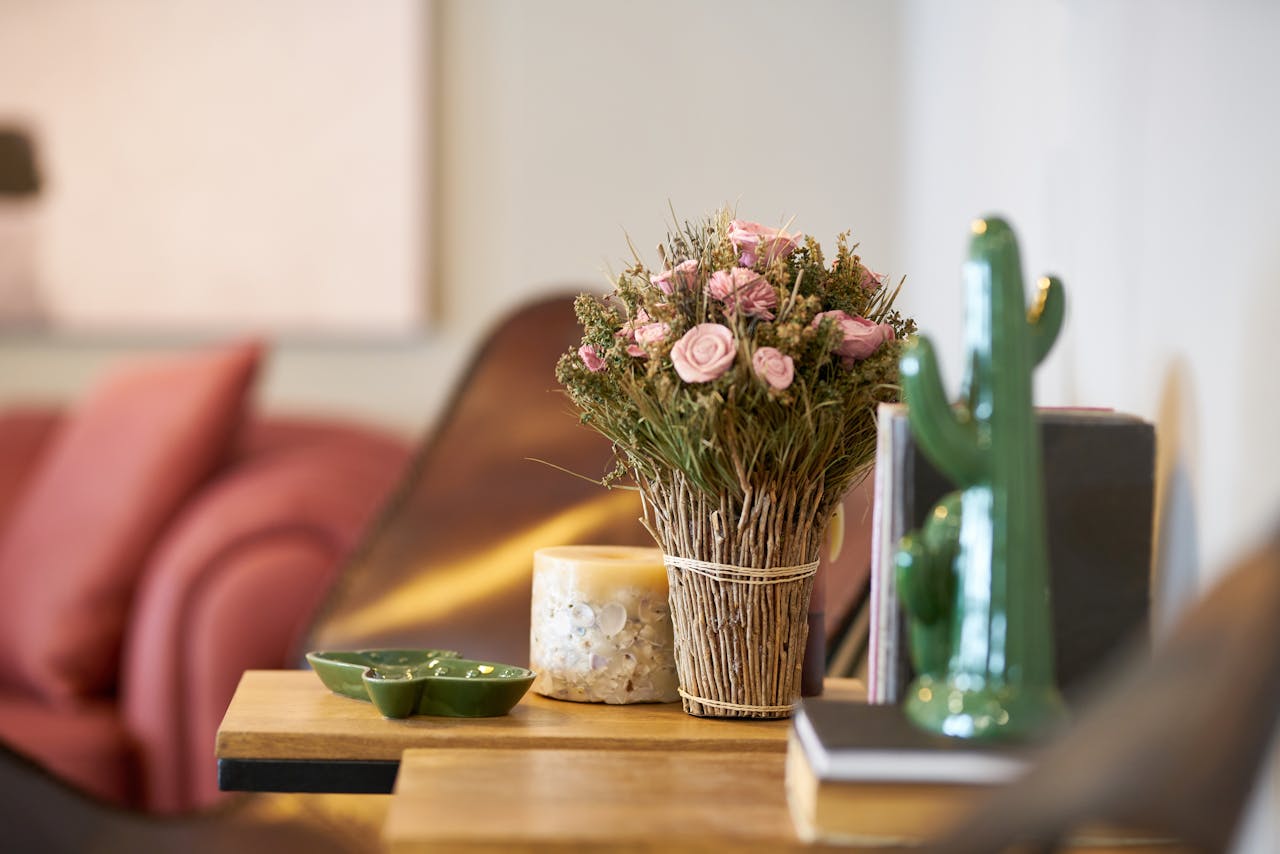 Elegant floral arrangement on a wooden table in a modern cozy interior setting.