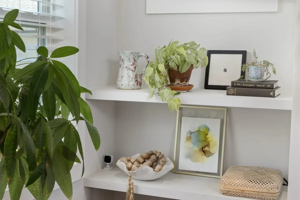Modern Shelf Styling Ideas Modern shelf styled with potted plants, books, and decor art